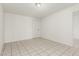 A well-lit bedroom featuring tile floors and neutral walls at 1512 W Crescent Ave, Mesa, AZ 85202