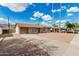 Charming single-story home with driveway, mature trees, and low-maintenance gravel landscaping at 1512 W Crescent Ave, Mesa, AZ 85202