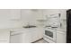 A close up of the kitchen with white cabinets, appliances, and a stainless steel sink at 1512 W Crescent Ave, Mesa, AZ 85202