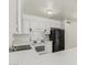 Kitchen area with white cabinets, countertops, and black refrigerator at 1512 W Crescent Ave, Mesa, AZ 85202