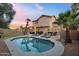 Home exterior showcasing pool, lounge chairs, outdoor kitchen, putting green and lush landscaping at 1574 E Scott Ave, Gilbert, AZ 85234