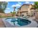 Spacious backyard features a sparkling pool, putting green, palm trees and an outdoor bar at 1574 E Scott Ave, Gilbert, AZ 85234