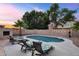 Private backyard oasis with a sparkling pool, built-in fireplace, and comfortable lounge seating at 1574 E Scott Ave, Gilbert, AZ 85234
