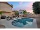 Home exterior showcasing pool, lounge chairs, outdoor kitchen, built in fireplace and lush landscaping at 1574 E Scott Ave, Gilbert, AZ 85234