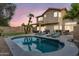 Spacious backyard features a sparkling pool, putting green, palm trees and an outdoor bar at 1574 E Scott Ave, Gilbert, AZ 85234