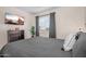 Inviting bedroom with ceiling fan, mounted television, and a large window overlooking the exterior at 1574 E Scott Ave, Gilbert, AZ 85234