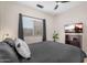 Inviting bedroom with ceiling fan, mounted television, and a large window overlooking the exterior at 1574 E Scott Ave, Gilbert, AZ 85234