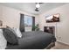 Cozy bedroom featuring a ceiling fan, mounted TV, and a large window at 1574 E Scott Ave, Gilbert, AZ 85234