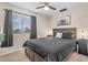 Relaxing bedroom features a ceiling fan, a large window, and comfy pillows at 1574 E Scott Ave, Gilbert, AZ 85234