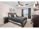 Cozy bedroom with ceiling fan, neutral walls, and carpet flooring at 1574 E Scott Ave, Gilbert, AZ 85234