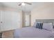 Inviting bedroom offers a ceiling fan, closet, and calming, neutral colors at 1574 E Scott Ave, Gilbert, AZ 85234