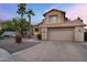 Two-story home featuring a two-car garage, desert landscaping, and a red tile roof at 1574 E Scott Ave, Gilbert, AZ 85234