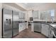 Bright kitchen features stainless steel appliances, wood-look floors, and black granite countertops at 1574 E Scott Ave, Gilbert, AZ 85234