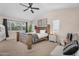 Primary bedroom features a ceiling fan, natural light, and a seating area at 1574 E Scott Ave, Gilbert, AZ 85234