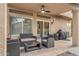 Inviting covered patio with outdoor seating, ceiling fan, and a view of the backyard pool at 1574 E Scott Ave, Gilbert, AZ 85234