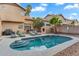 Relaxing backyard pool area with lush landscaping, lounge chairs, and outdoor kitchen island at 1574 E Scott Ave, Gilbert, AZ 85234