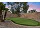 Well maintained backyard putting green with brick border and desert landscaping for a relaxing outdoor experience at 1574 E Scott Ave, Gilbert, AZ 85234