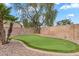 Backyard putting green with desert landscaping and brick border at 1574 E Scott Ave, Gilbert, AZ 85234