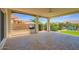 This outdoor living area has a built-in barbecue and a ceiling fan at 16729 W Alvarado Dr, Goodyear, AZ 85395