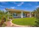Beautiful backyard with artificial grass, covered patio, and desert landscaping, ideal for relaxation at 16729 W Alvarado Dr, Goodyear, AZ 85395
