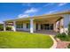 Spacious backyard showcasing a covered patio, artificial turf, and well-designed landscaping at 16729 W Alvarado Dr, Goodyear, AZ 85395