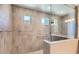 Modern tiled shower with glass enclosure and tiled walls and floors at 16729 W Alvarado Dr, Goodyear, AZ 85395