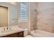 A full bathroom with a tiled shower-tub, wood vanity and white countertops at 16729 W Alvarado Dr, Goodyear, AZ 85395