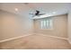 This bedroom features neutral walls, carpet, and a ceiling fan at 16729 W Alvarado Dr, Goodyear, AZ 85395