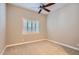 Carpeted bedroom with window and ceiling fan at 16729 W Alvarado Dr, Goodyear, AZ 85395
