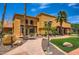 Beautiful clubhouse featuring manicured grounds, desert landscaping, and brick pathways at 16729 W Alvarado Dr, Goodyear, AZ 85395