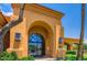 Fitness Center entrance showcasing a modern glass door, desert landscaping, and convenient parking at 16729 W Alvarado Dr, Goodyear, AZ 85395