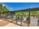 Fenced dog park featuring shaded areas, play equipment, and posted rules for pet owners at 16729 W Alvarado Dr, Goodyear, AZ 85395