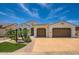 Stunning single-story home featuring a tile roof, manicured lawn and attached garage at 16729 W Alvarado Dr, Goodyear, AZ 85395