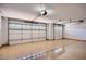 Spacious two-car garage featuring epoxy floors and paneled doors at 16729 W Alvarado Dr, Goodyear, AZ 85395