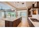 Open-concept kitchen features a large island, stainless steel appliances, and pendant lighting at 16729 W Alvarado Dr, Goodyear, AZ 85395