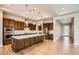 Gourmet kitchen with wood cabinets, large island and stainless steel appliances at 16729 W Alvarado Dr, Goodyear, AZ 85395