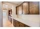 Beautiful kitchen with ample cabinetry, white subway tile backsplash, and wood-look flooring at 16729 W Alvarado Dr, Goodyear, AZ 85395