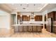Gourmet kitchen with wood cabinets, large island and pendant lighting at 16729 W Alvarado Dr, Goodyear, AZ 85395