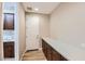 A laundry room featuring wooden cabinets, counters, a sink, and an exterior door at 16729 W Alvarado Dr, Goodyear, AZ 85395