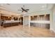Open-concept living room and gourmet kitchen featuring modern wood floors at 16729 W Alvarado Dr, Goodyear, AZ 85395