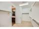 Spacious walk-in closet with built-in shelving and racks leading to a vanity area at 16729 W Alvarado Dr, Goodyear, AZ 85395