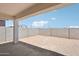 View of the backyard, partially covered patio, block fencing, and desert landscaping at 18262 W La Senda Dr, Surprise, AZ 85387