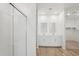 Bright bathroom with double sinks, white cabinets, and a glass-enclosed shower, providing a sleek design at 18262 W La Senda Dr, Surprise, AZ 85387