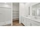 Bathroom featuring double sinks with a walk-in shower and large linen closet at 18262 W La Senda Dr, Surprise, AZ 85387