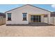 Rear exterior of home featuring covered patio, desert landscaping, and block wall at 18262 W La Senda Dr, Surprise, AZ 85387