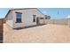 Exterior side view of the home with a covered patio and desert landscaping at 18262 W La Senda Dr, Surprise, AZ 85387