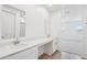 Bathroom with dual sinks, white countertops, and neutral-toned flooring at 18268 W La Senda Dr, Surprise, AZ 85387