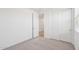 Carpeted bedroom with closet features a walk-in closet and plenty of natural light from the large window at 18268 W La Senda Dr, Surprise, AZ 85387