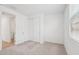 Carpeted bedroom with closet features a walk-in closet and plenty of natural light from the large window at 18268 W La Senda Dr, Surprise, AZ 85387