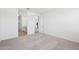 Carpeted bedroom features a walk-in closet and open view into the modern kitchen at 18268 W La Senda Dr, Surprise, AZ 85387